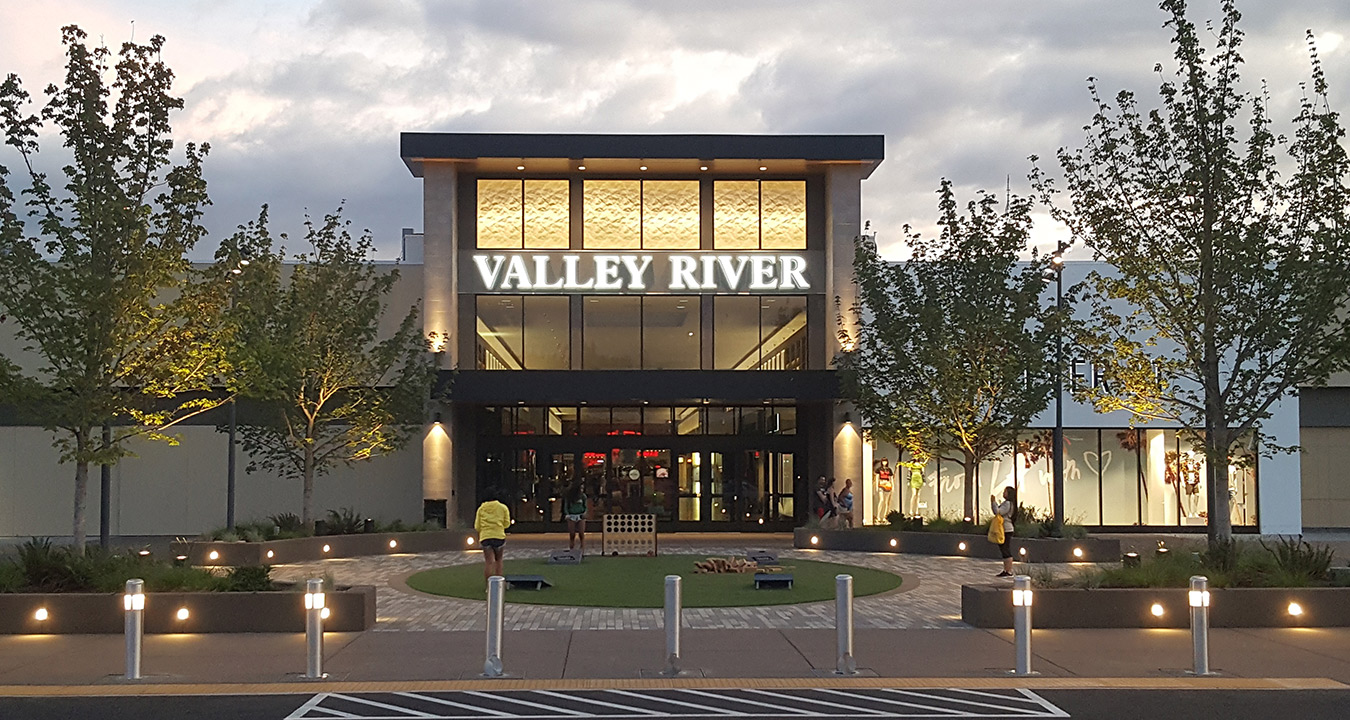 Valley River Center's entrance and plaza at dusk