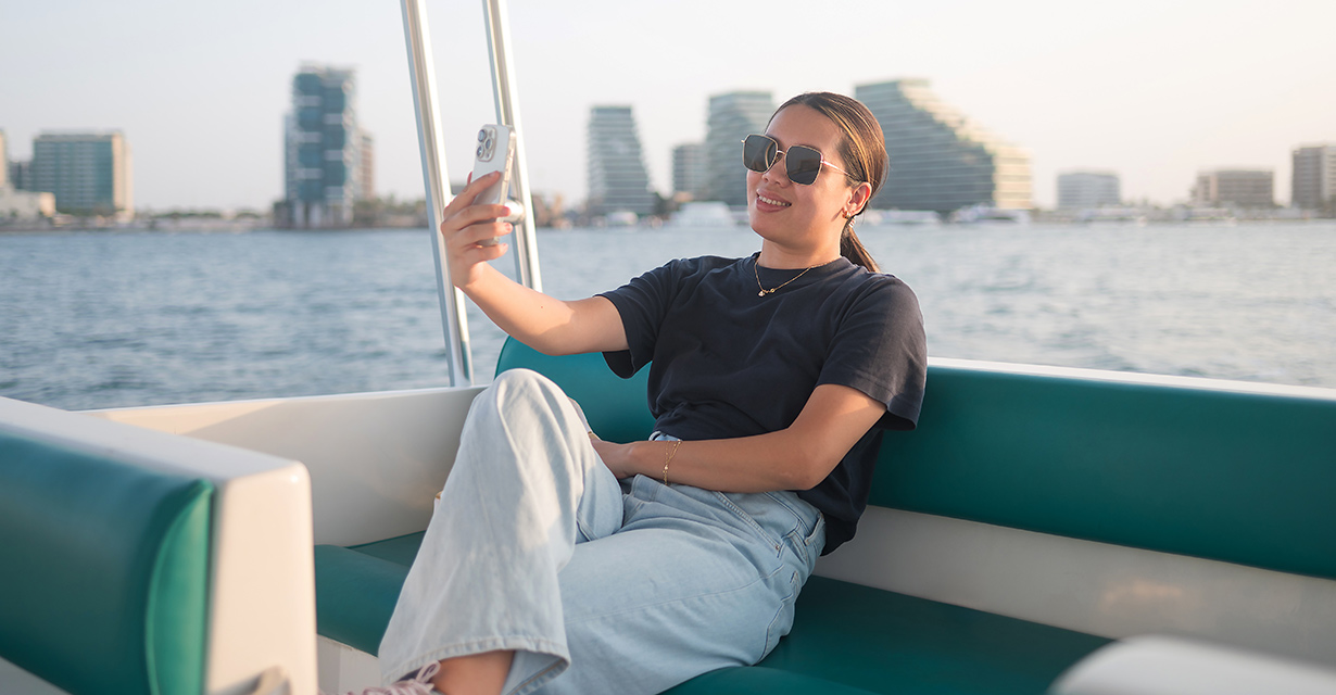 A woman on a boat looking at her phone