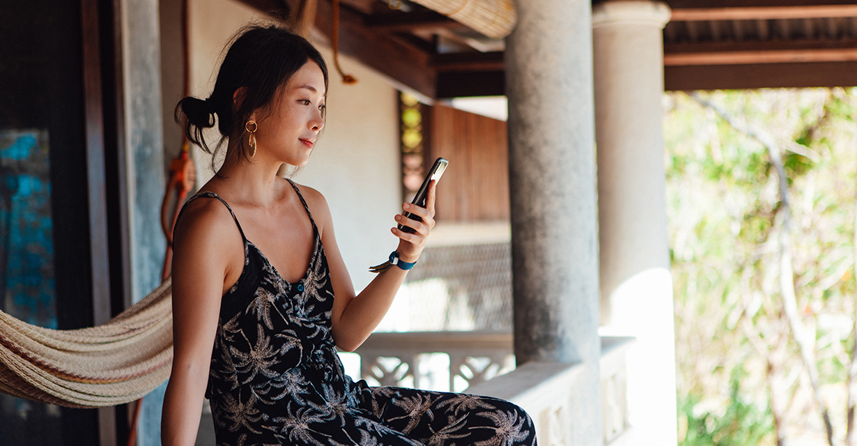 A woman on vacation at a resort texting