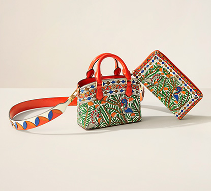 A Tory Burch purse with a tropical print design
