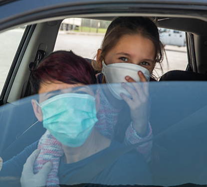 Teens in a car waiting to get a COVID test