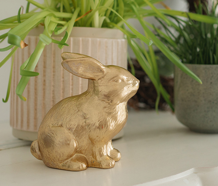 A gold bunny statuette on a mantle