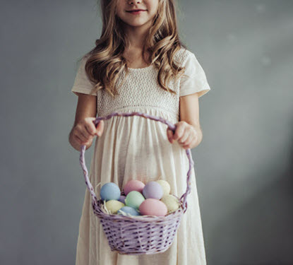 Little girl holding an Easter egg basket