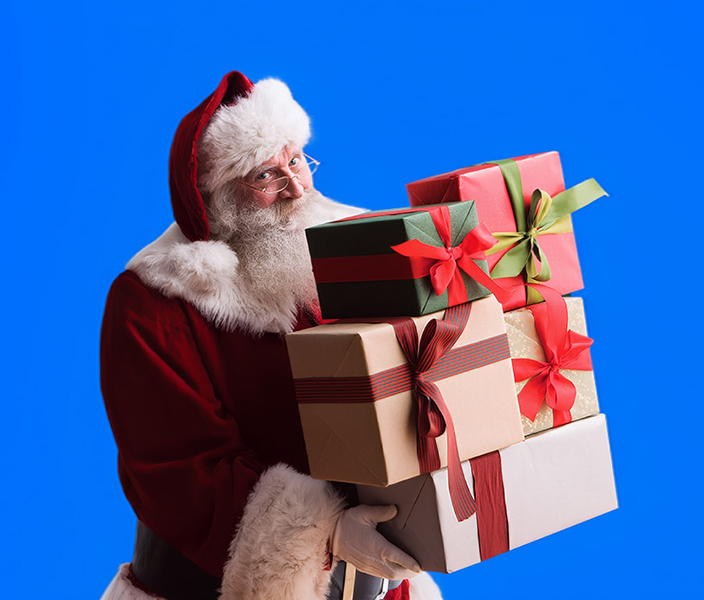 Santa holding a stack of presents