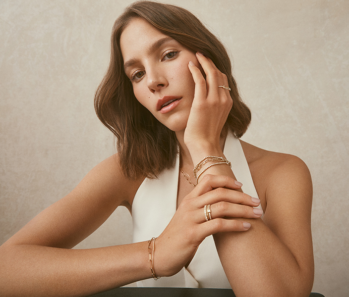 Woman posing with hand on chin showing jewelry