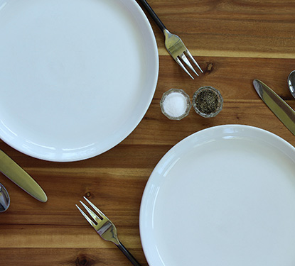 A dinner table set with plates and silverware