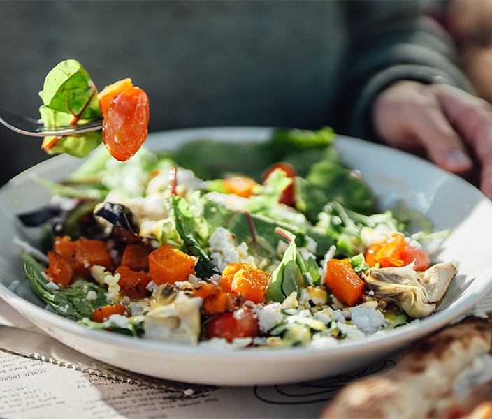 A person eating a salad