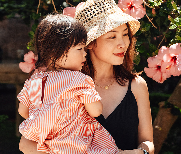 A mom holding her daughter at an event