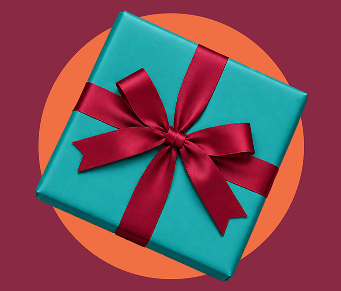 Teal gift box with a red ribbon against a burgundy and orange background.