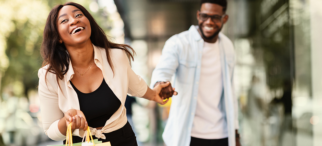 A young couple excitedly shopping together