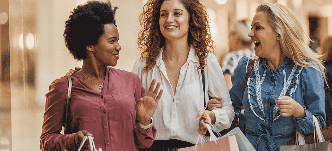 Three happy women shopping