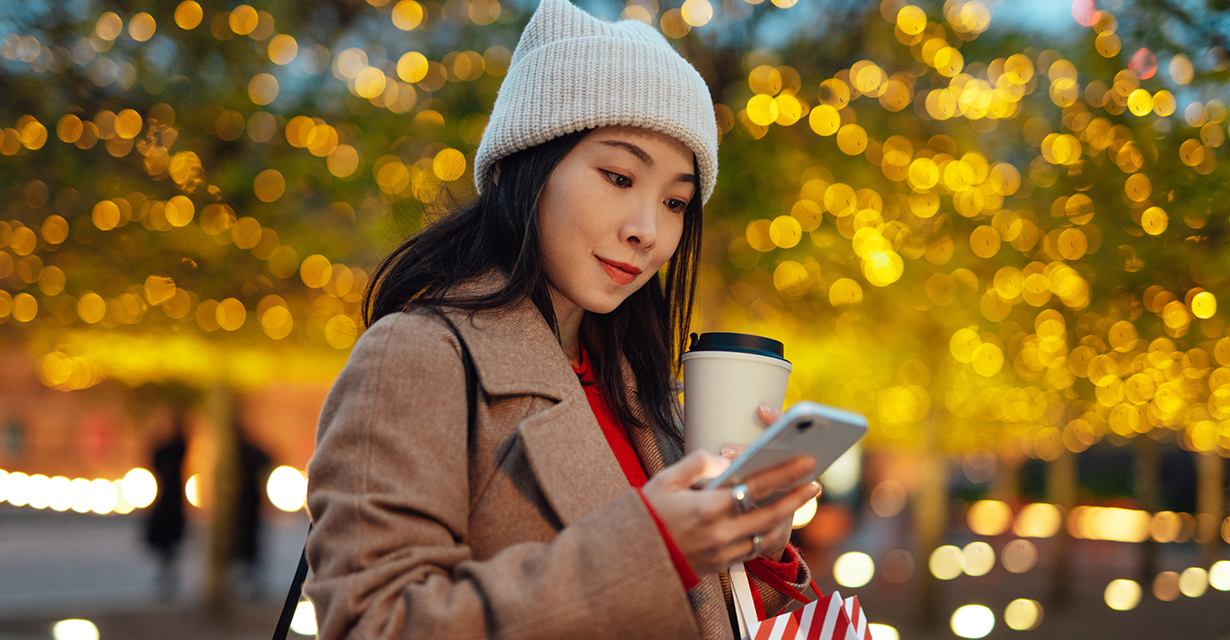 A woman using text concierge while holiday shopping