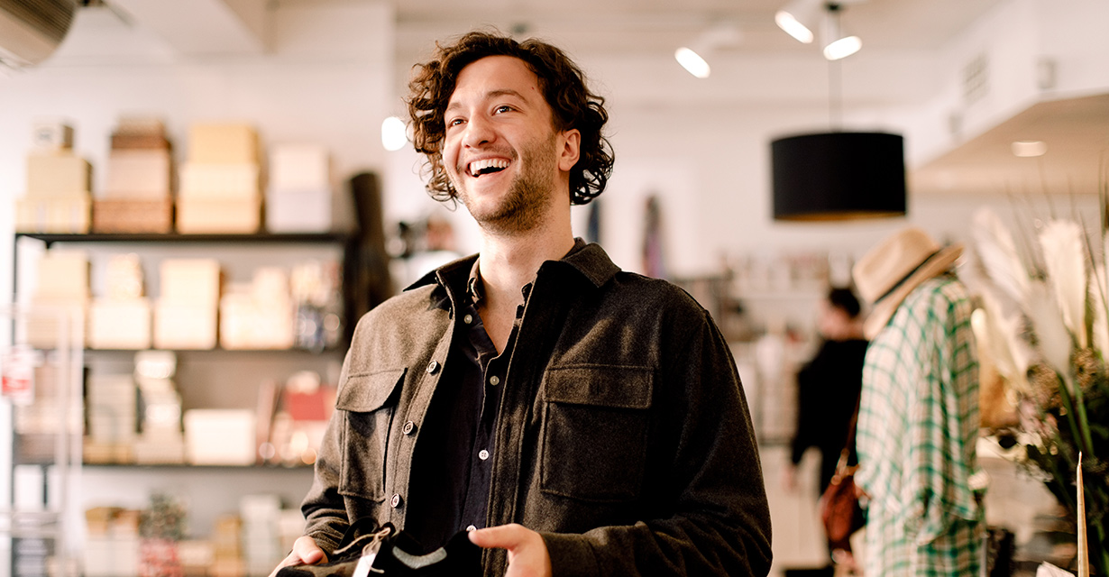 A smiling man shopping in a boutique