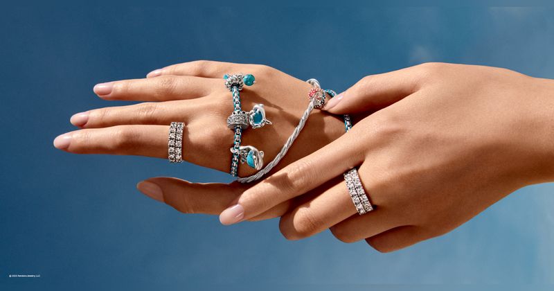 Pandora bracelets and rings being worn