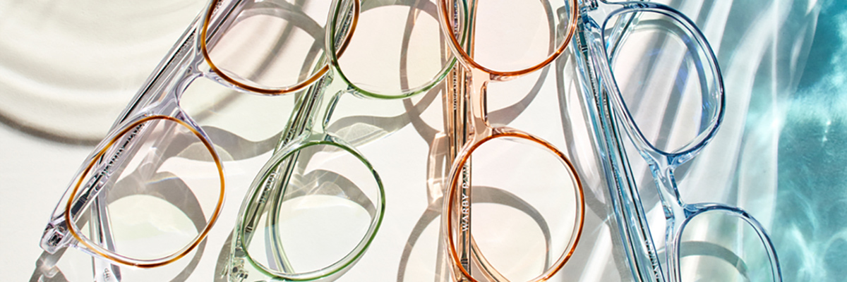 Four colorful pairs of Warby Parker glasses on display